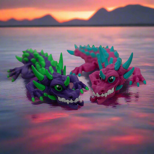 Two colorful dragon-like figurines 